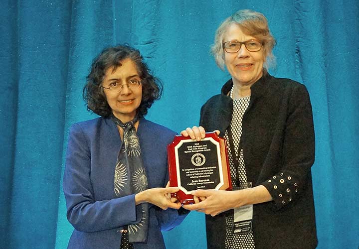 Sunita Satyapal presents an award plaque to Jean Baronas.