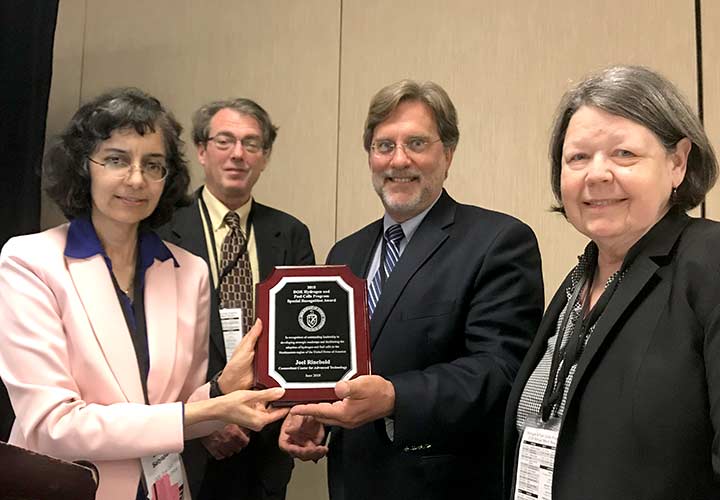 FCTO staff present an award plaque to Joel Rinebold.