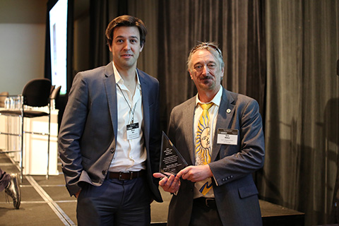 Shaun Alia stands with his award trophy alongside Eric Miller.