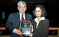 Photo of one man and one woman posing for a picture. The man is holding an award. L to R: Rajesh Ahluwahlia, AVL; Sunita Satyapal, Fuel Cell Technologies Office (FCTO).