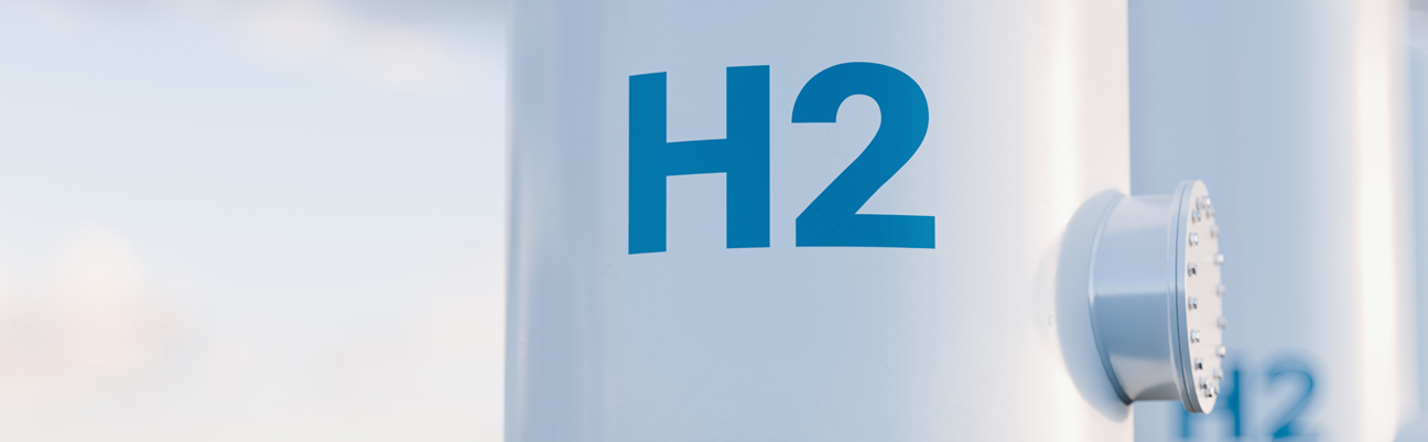 Tall white tanks with H2 painted in blue on the front.